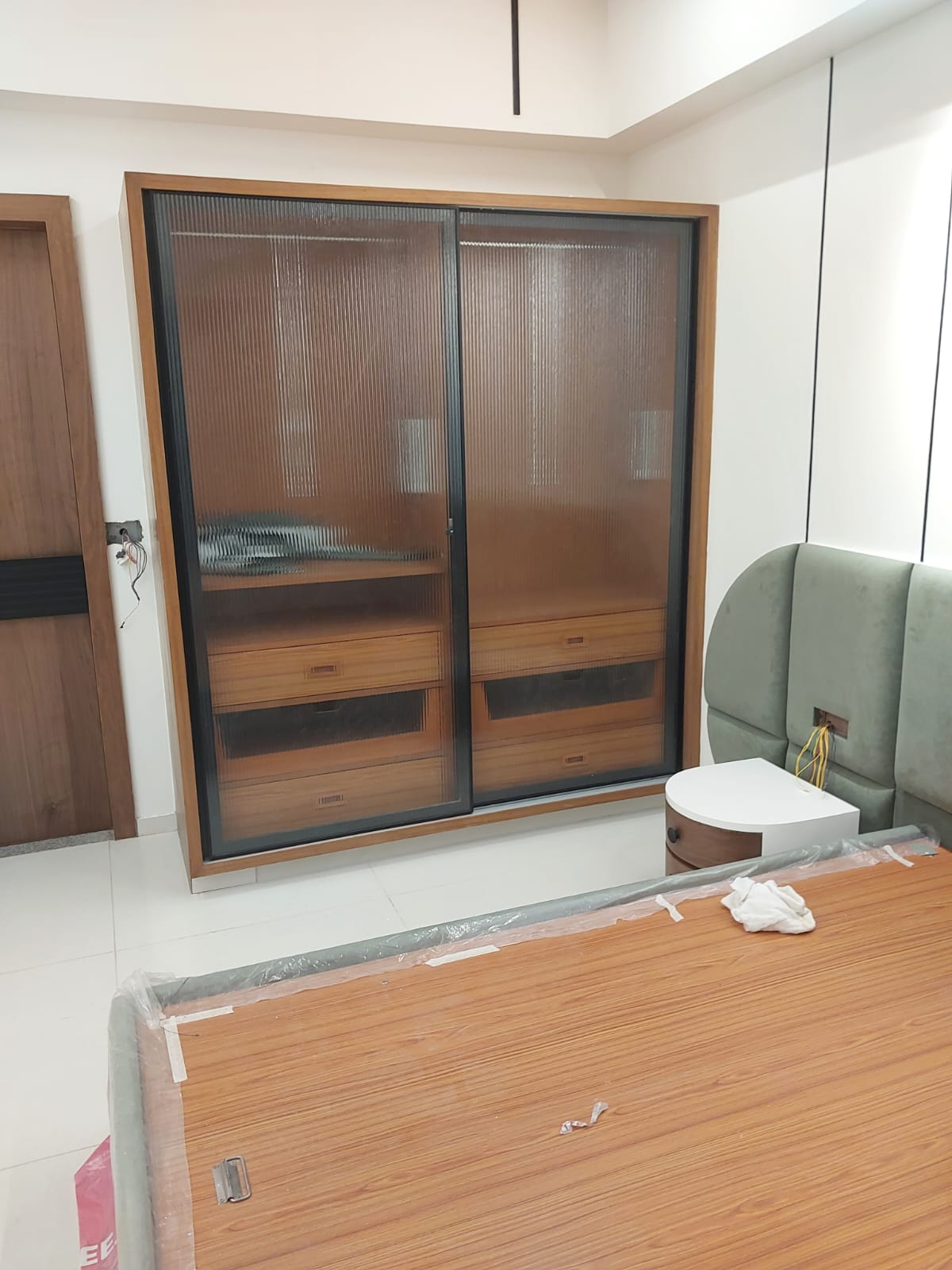 Walnut wardrobe with fluted glass & green headboard