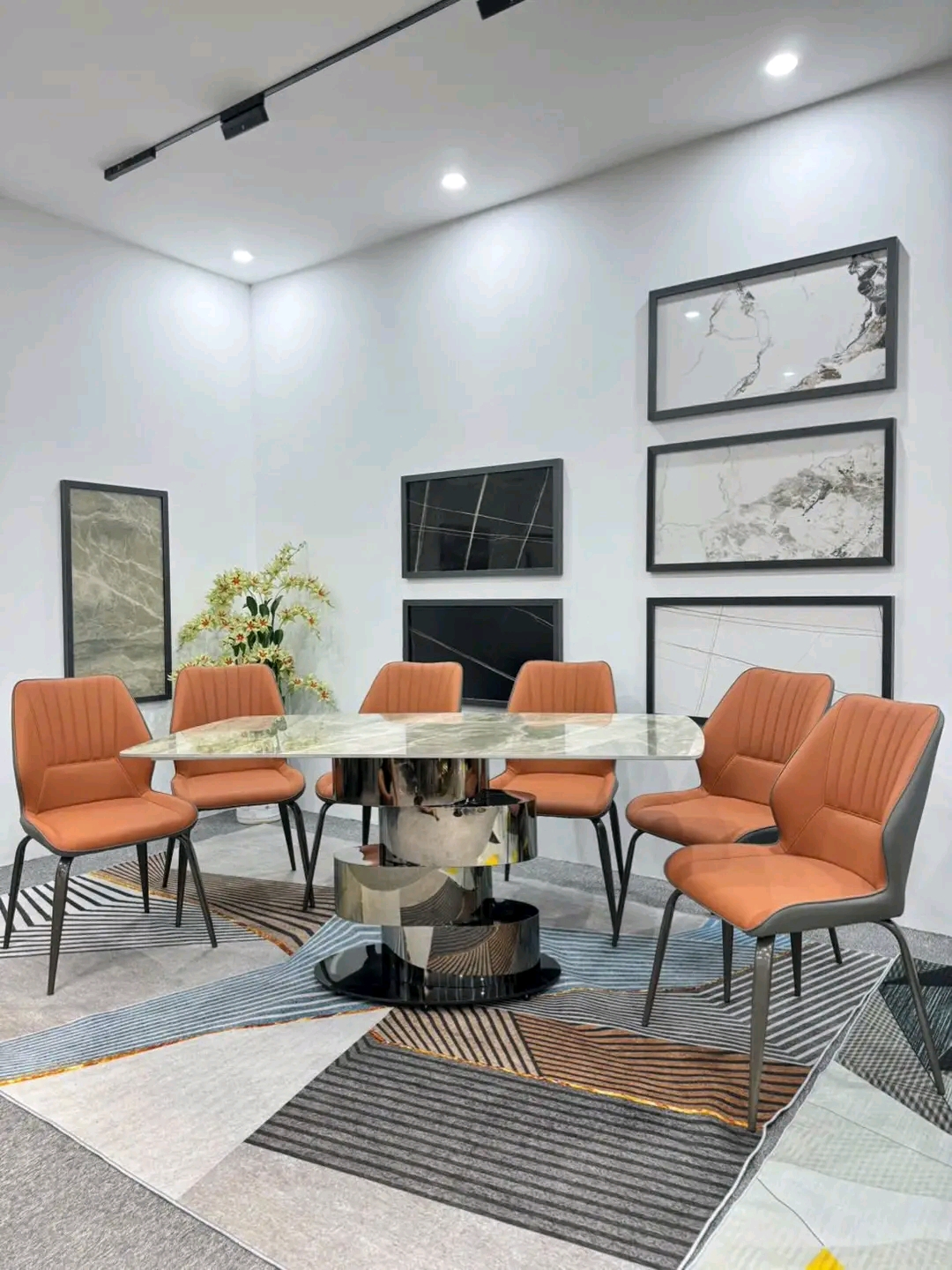 Marble oval table with 8 orange-leather chairs