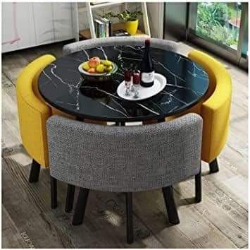 Round black marble table with yellow & grey chairs