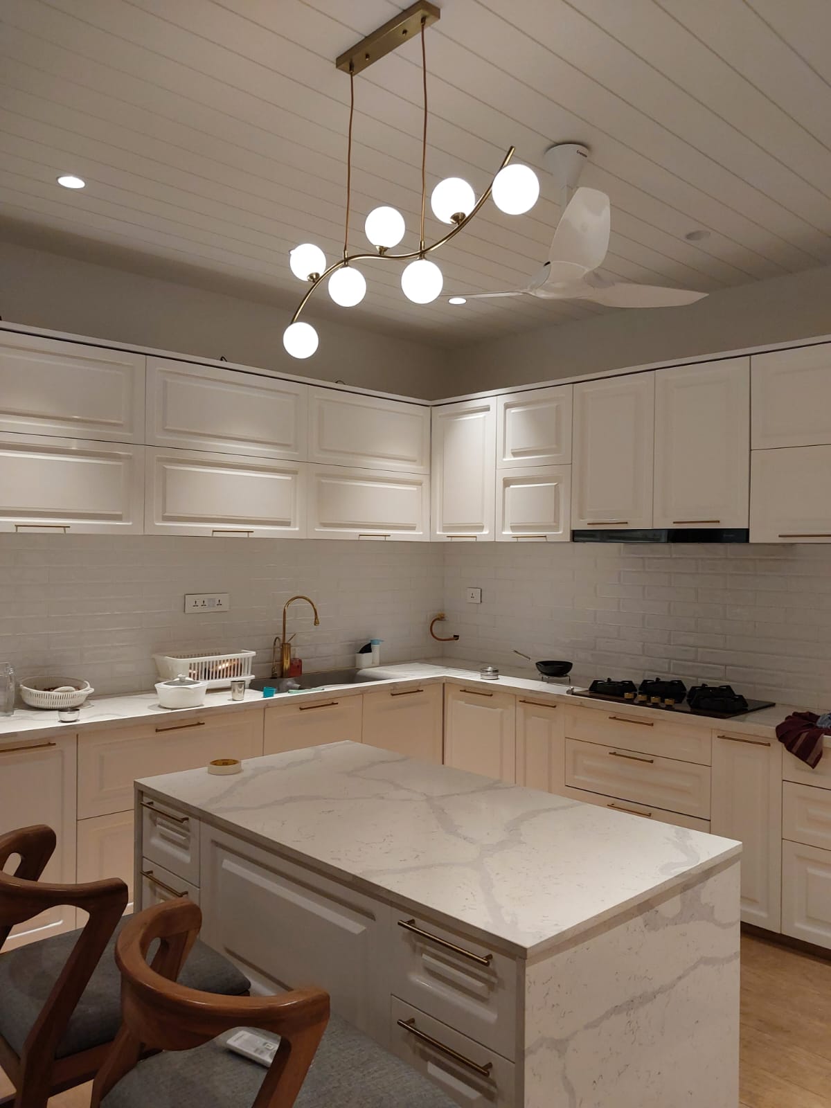 All-white shaker kitchen with marble island