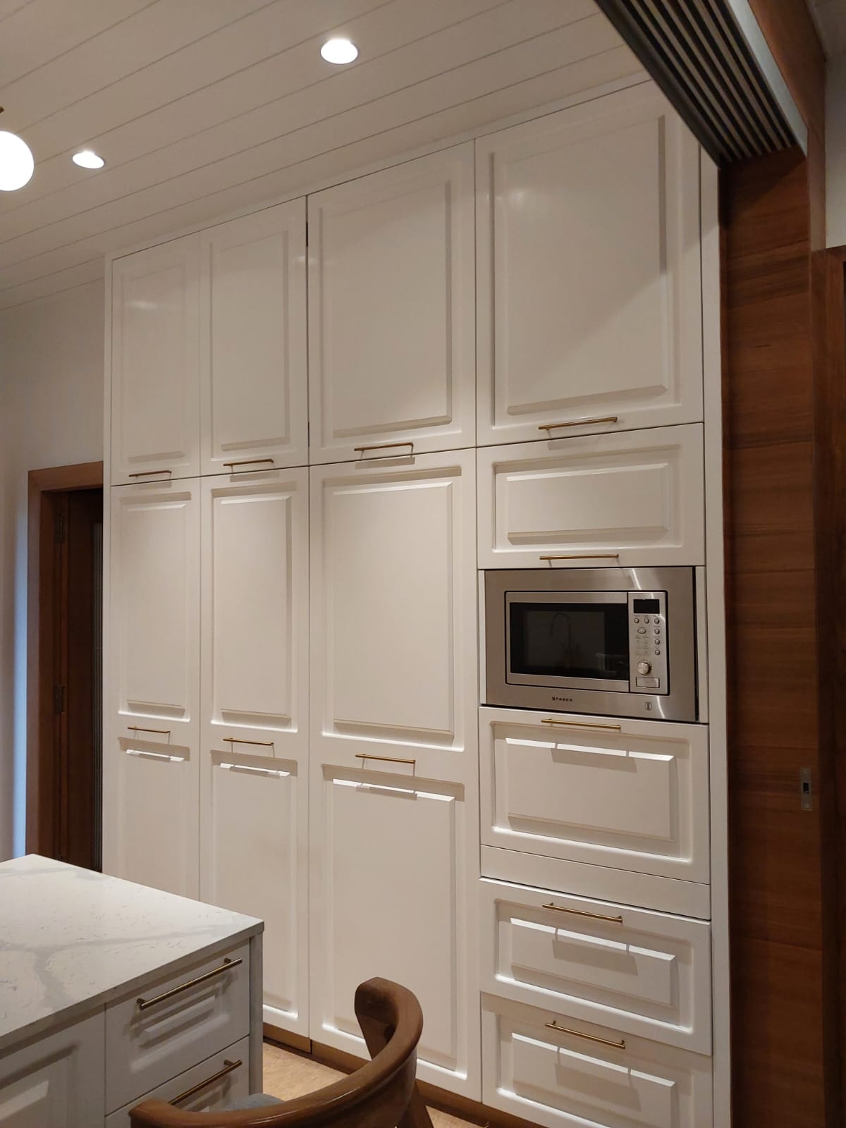 White shaker tall cabinets with integrated microwave