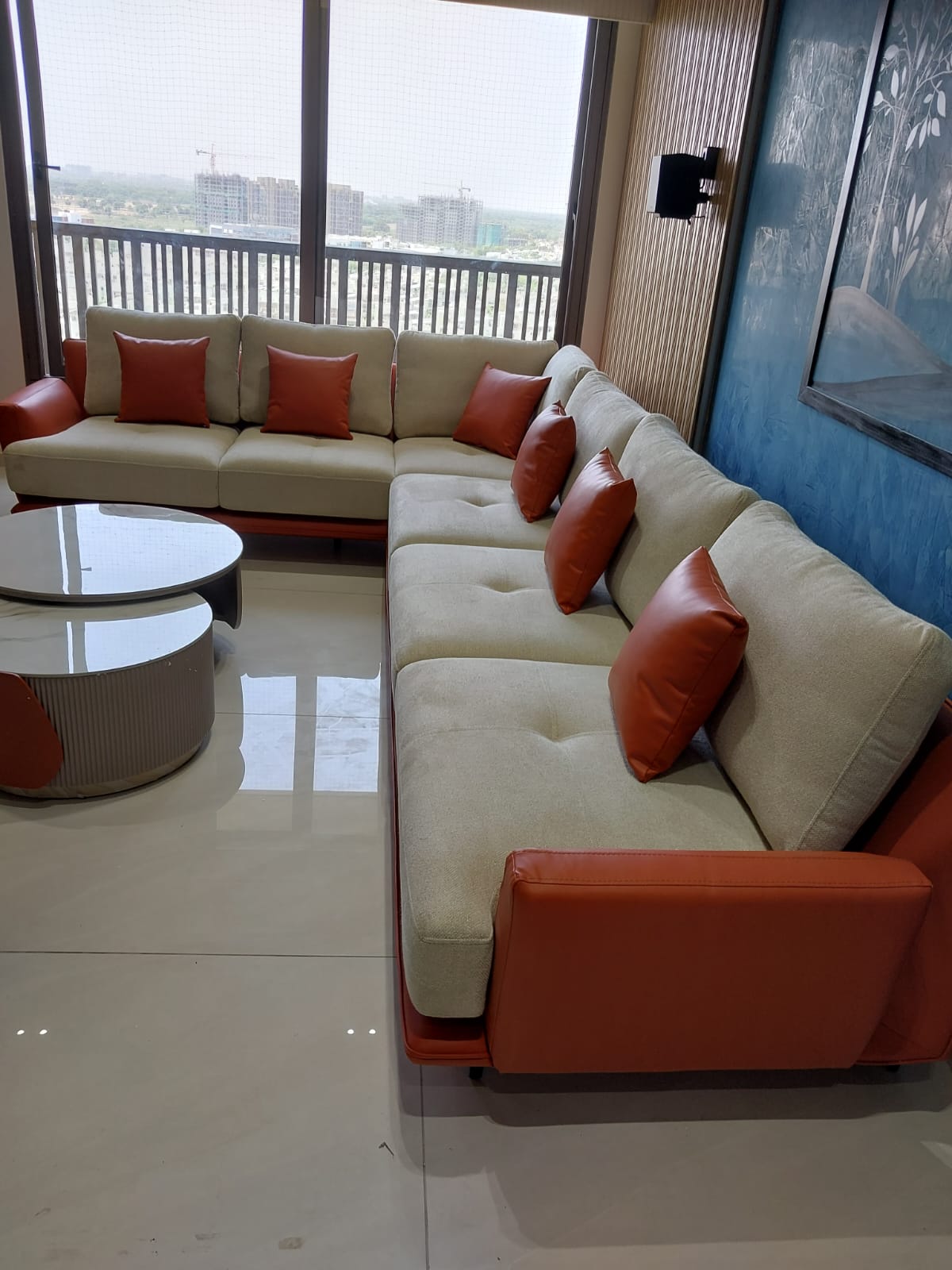 Cream & terracotta L-sofa with panoramic city view