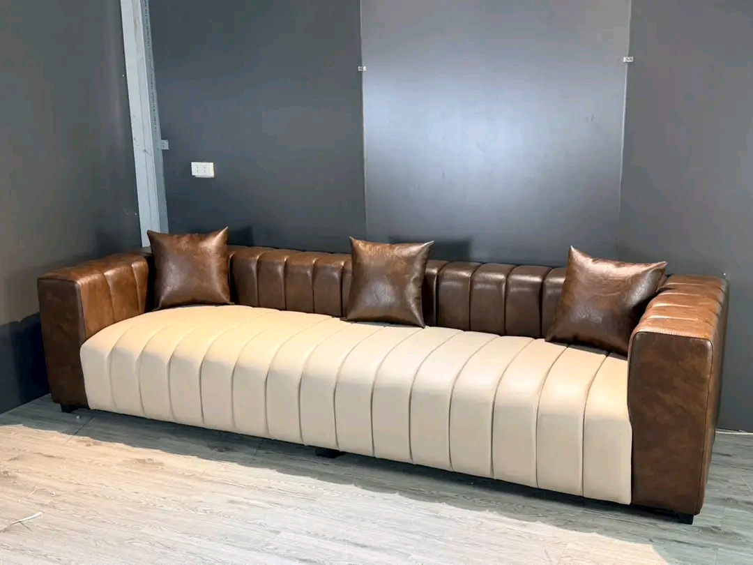 Brown channel-tufted sofa with matching cushions