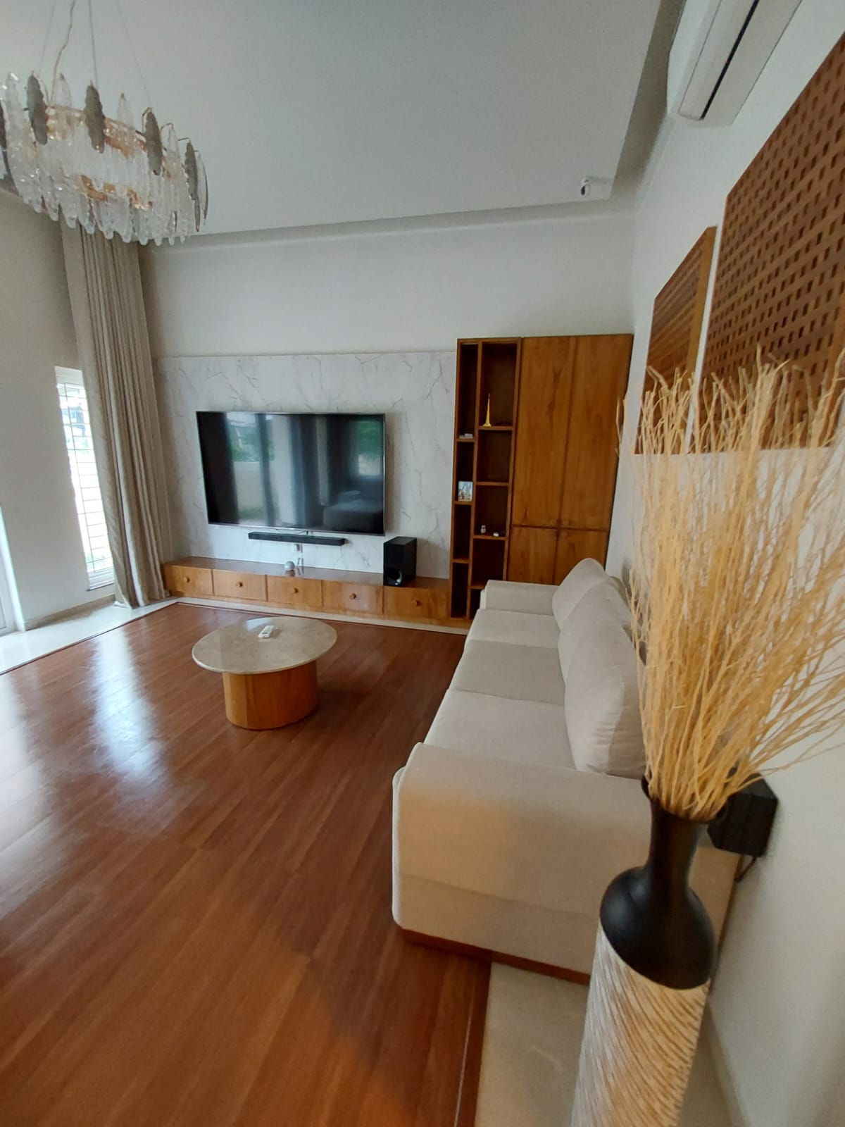 Cream sofa with walnut TV unit — wide view