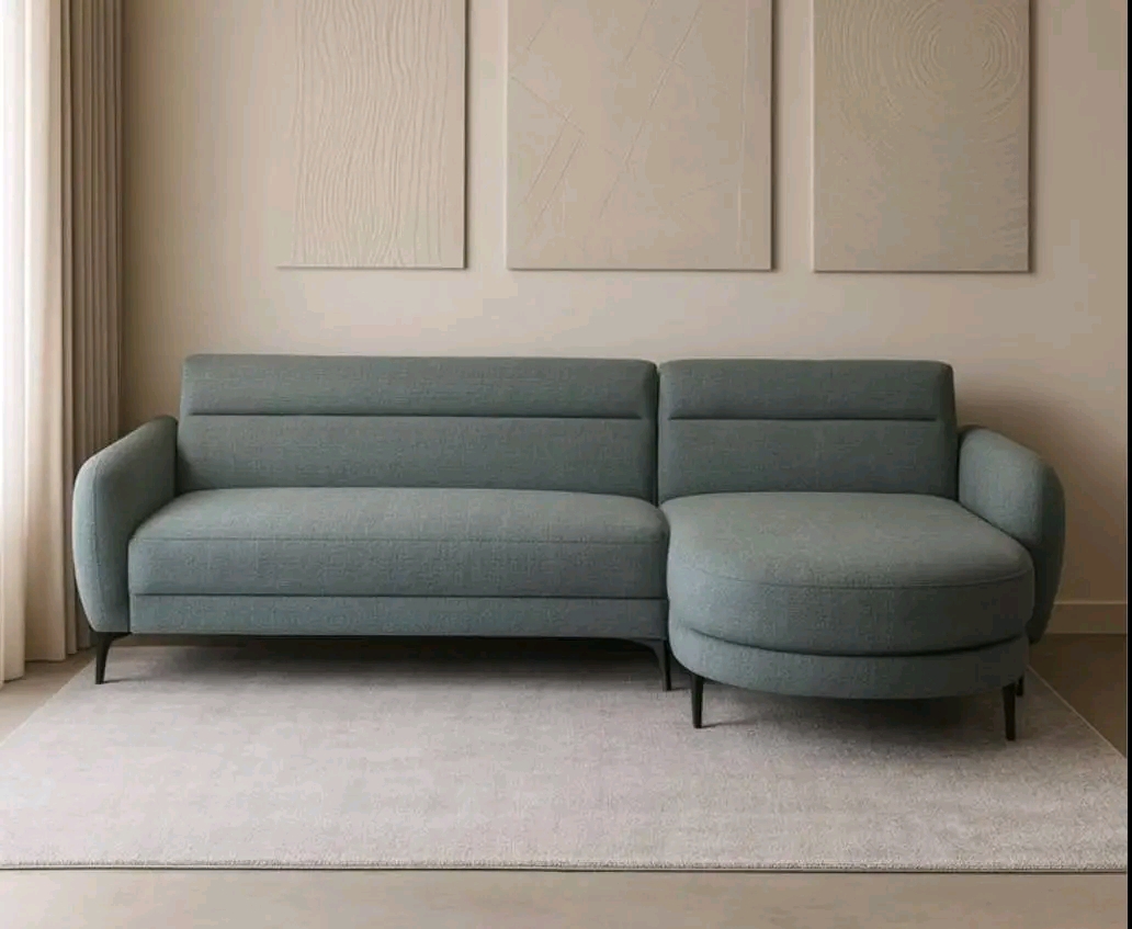 Sage-green sectional in a serene, minimal setting